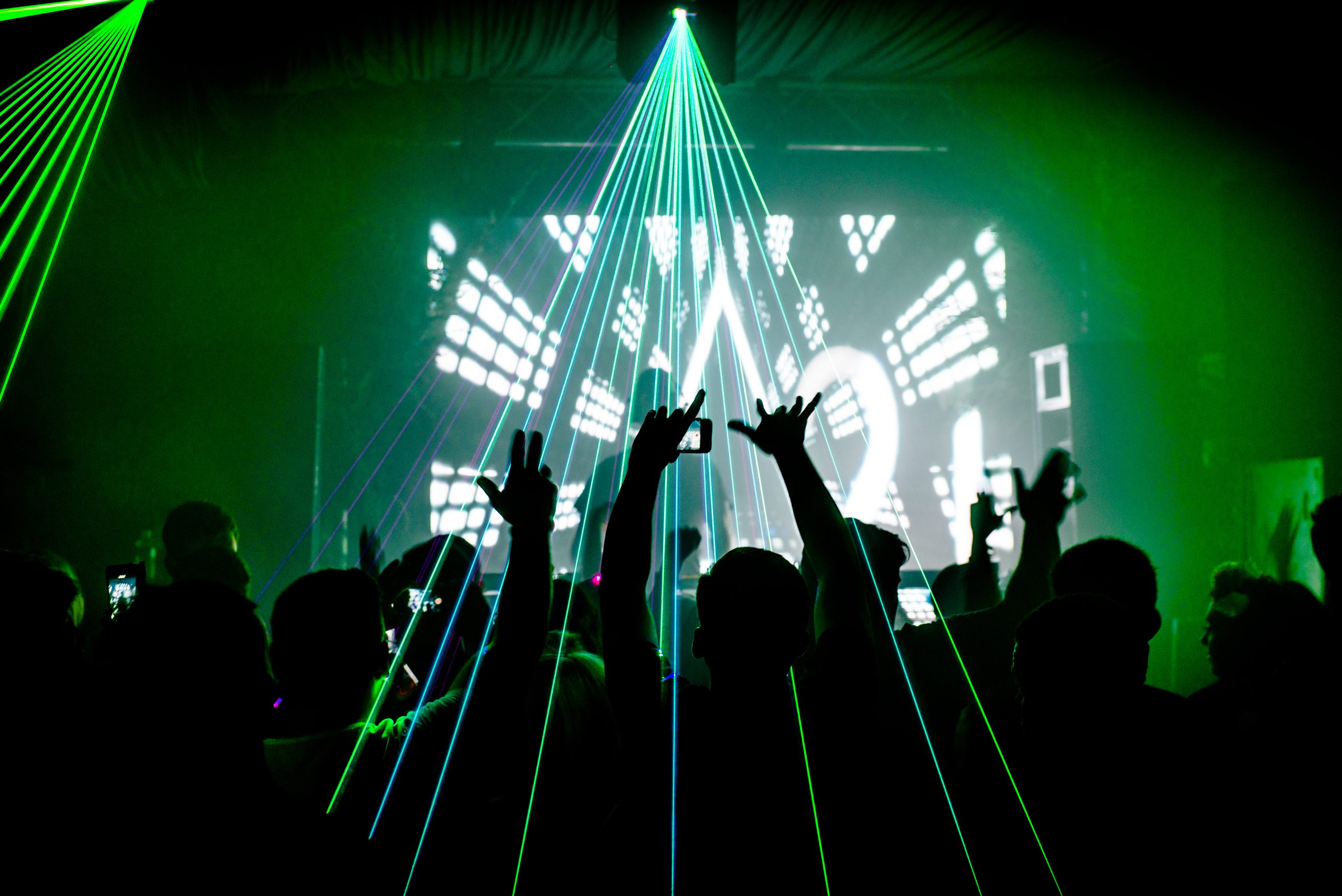 Nightclub,Man,With,Mobile,Phone,Recording,Lasers,At,Party,Rave